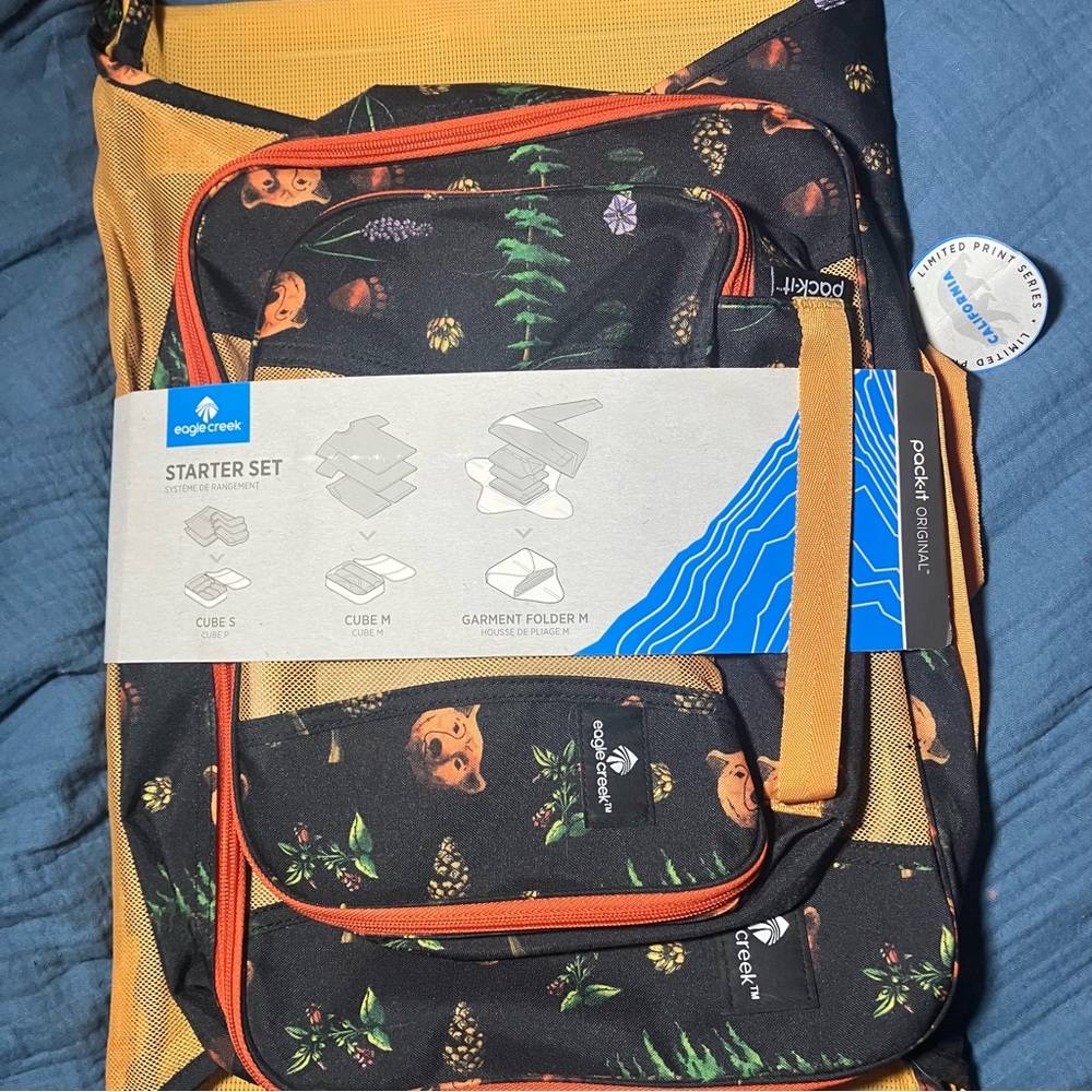 Eagle Creek packing cube set with garment folding bag. California bear print.